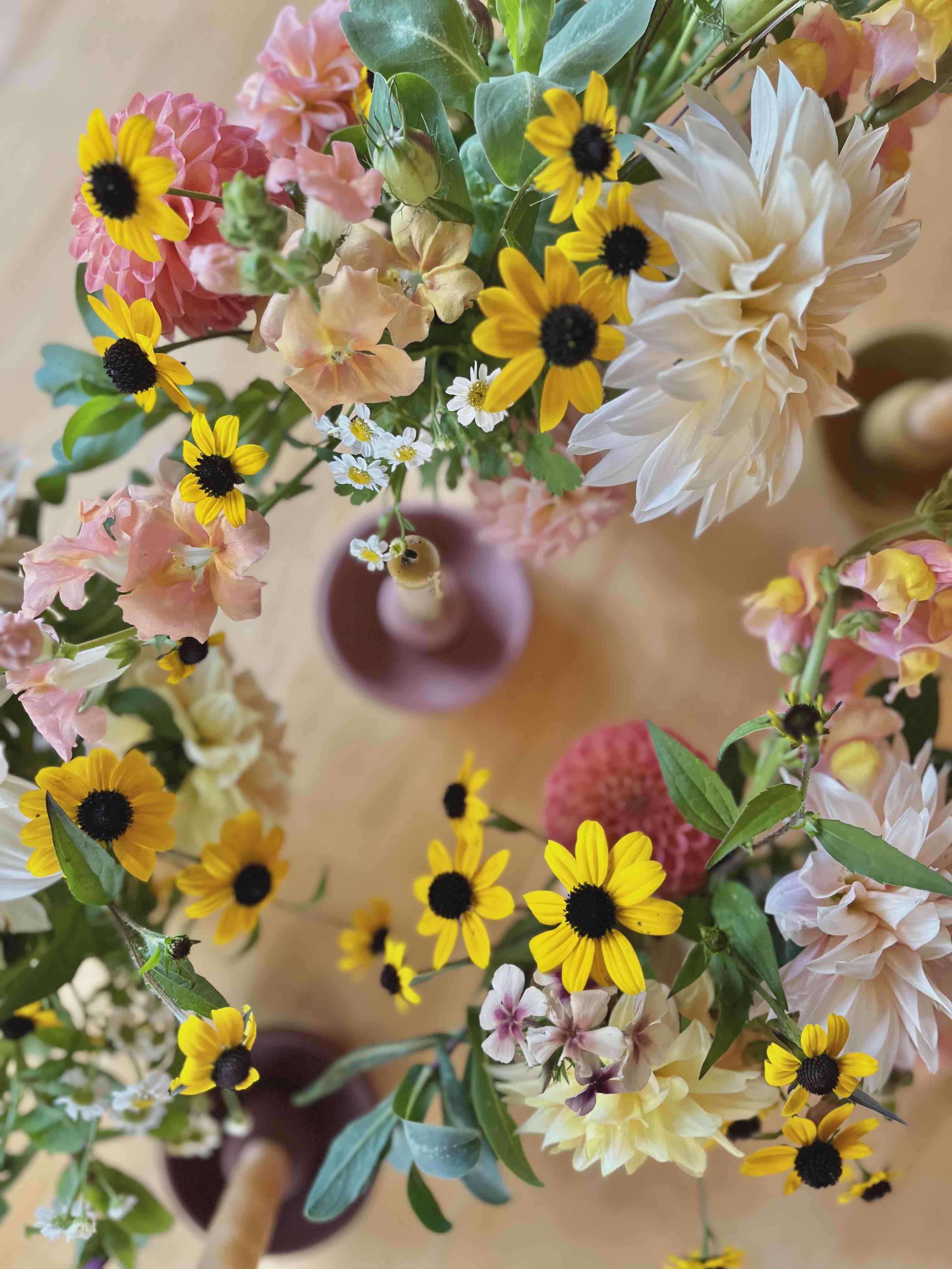 small bouquets of flowers in yellows, pinks and greens on table
